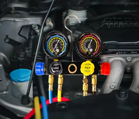 A dual-gauge automotive refrigerant manifold tool